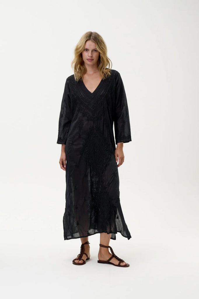 Woman wearing a oneseason Long Goa black dress on a white background