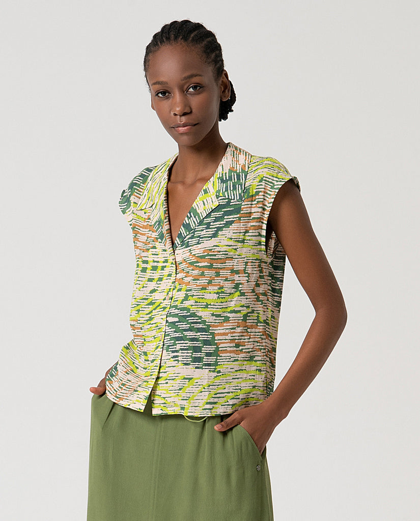 Surkana European Fashion Woman wearing a sleeveless patterned top and green pants on a white background