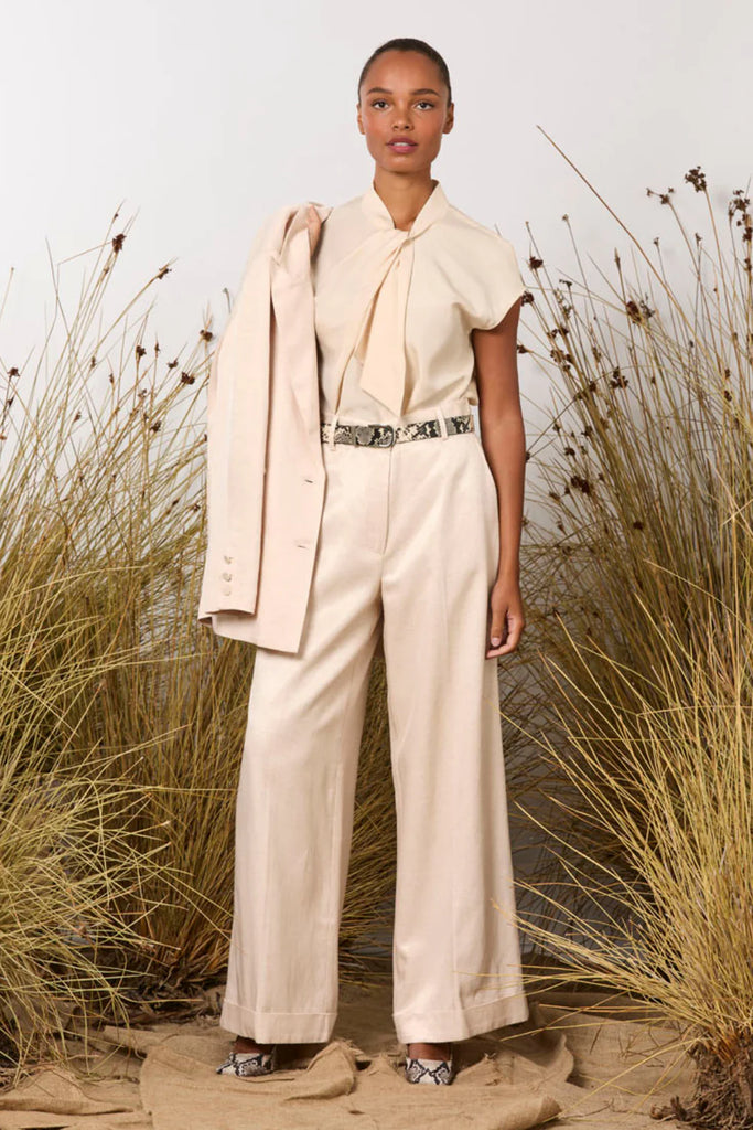 Woman in a M A Dainty shell pink suit featuring Dynasty Jacket and Dallas pant 
