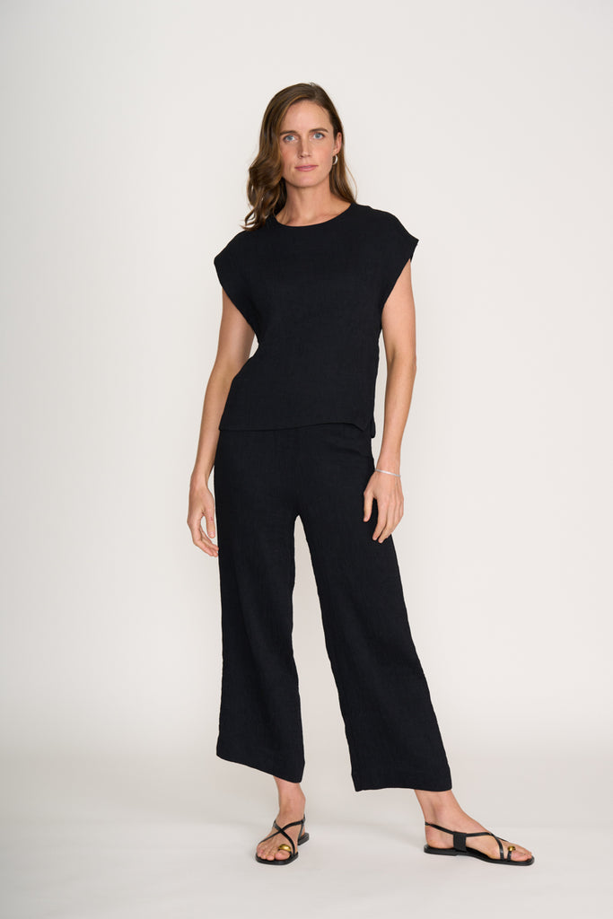 Woman wearing a black outfit on a white background