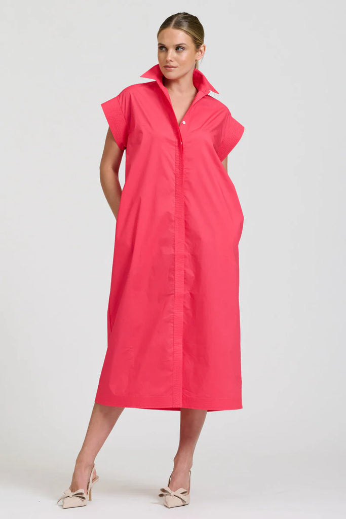 Woman wearing Shirty Fifi a pink dress against a white background